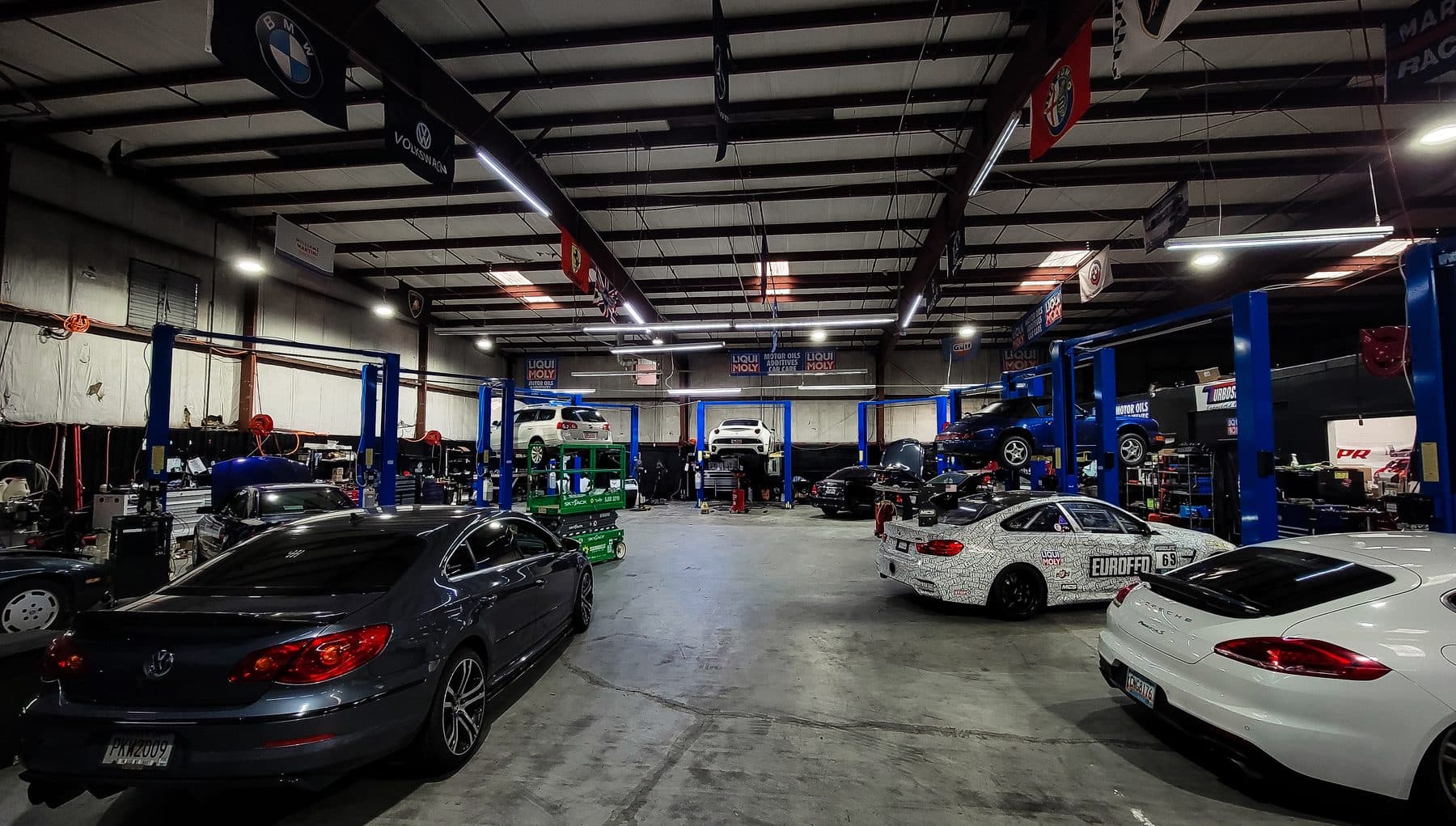 Automotive shop with lifts and linear LED high bays over service bays