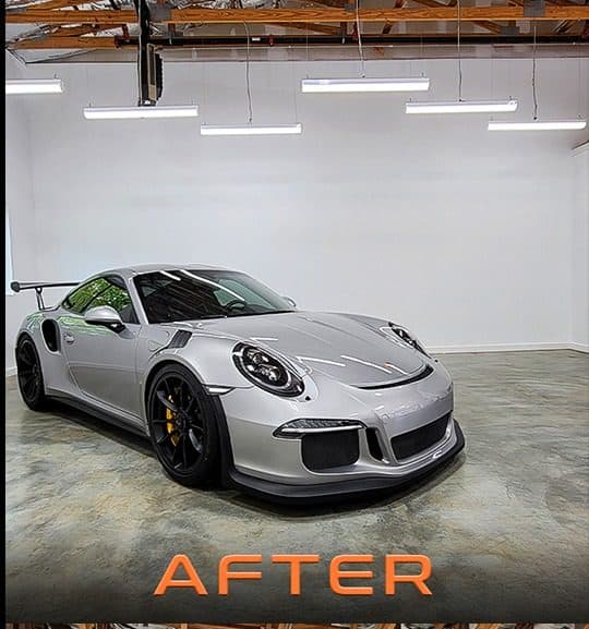 Silver Porsche under linear LED high bays on a shop floor after the upgrade