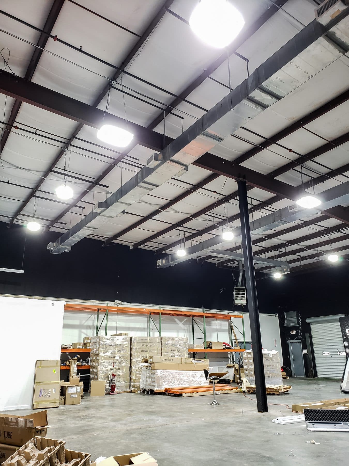 Warehouse with UFO high bays lighting pallet racking and open floor